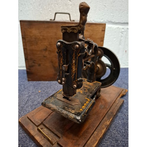 36 - A 19th Century, possibly Charles Raymond chainstitch sewing machine A/F, painted black and decorated... 