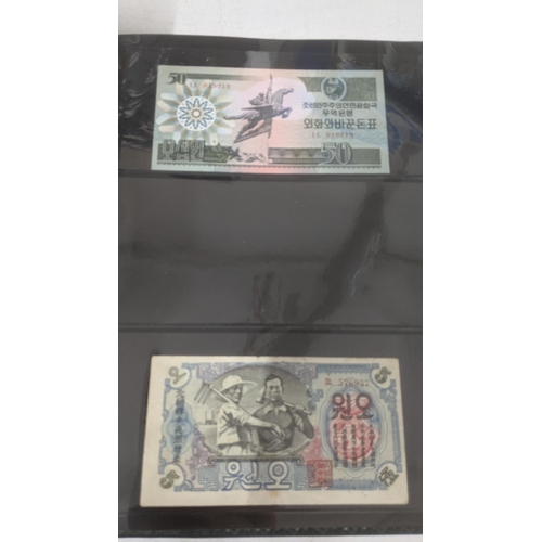 122 - Banknotes - An album of mixed Japanese and North Korean banknotes to include 1947 North Korean 5 won... 