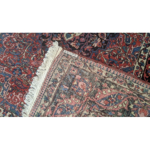 324 - A handwoven Persian design Tabriz rug on a blue and black ground, triple guard boarder with tasselle... 