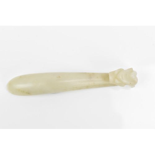 65 - A small Chinese carved white jade belt hook, with dragon head detail, 9 cm long, 22.6 grams
Location... 