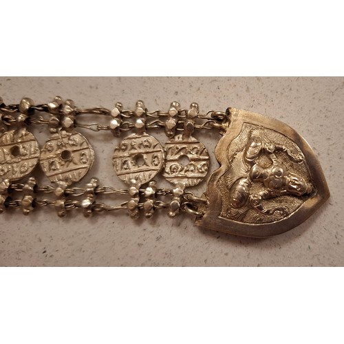 14 - A Burmese white metal belt having a buddha image to the buckle fastening, 33