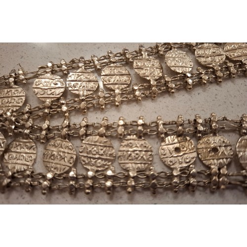 14 - A Burmese white metal belt having a buddha image to the buckle fastening, 33