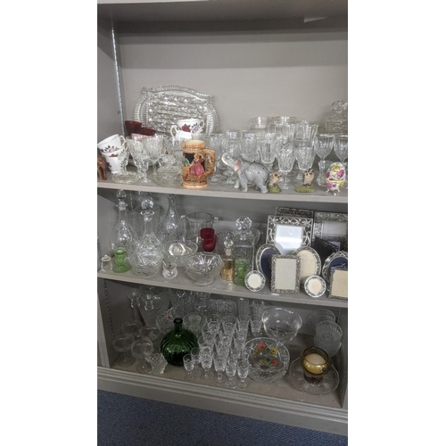 395 - A large mixed lot to include a quantity of crystal cut glass decanters, fruit bowl, drinking glasses... 