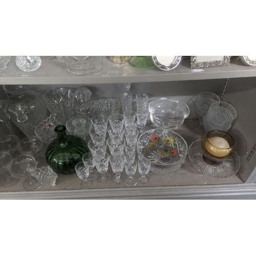 395 - A large mixed lot to include a quantity of crystal cut glass decanters, fruit bowl, drinking glasses... 