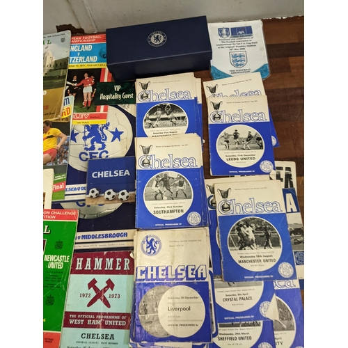 411 - A collection of football programmes and collectables, mainly Chelsea related to include Cup Final ex... 