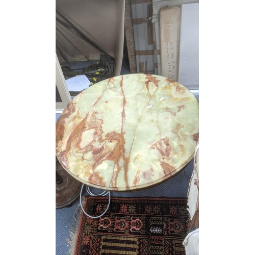 429 - A mid-20th century brass and green onyx style coffee table in circular form decorated with embossed ... 