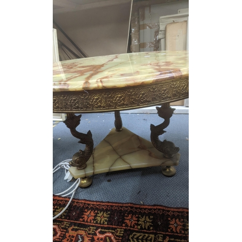 429 - A mid-20th century brass and green onyx style coffee table in circular form decorated with embossed ... 