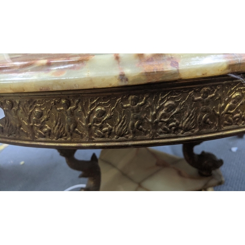 429 - A mid-20th century brass and green onyx style coffee table in circular form decorated with embossed ... 