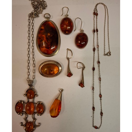 128 - A suite of white metal and amber effect jewellery, not hallmarked and previously tested negatively f... 