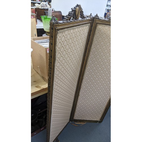 90 - A late 19th century French gilt folding three fold screen, having beige upholstery panels surrounded... 