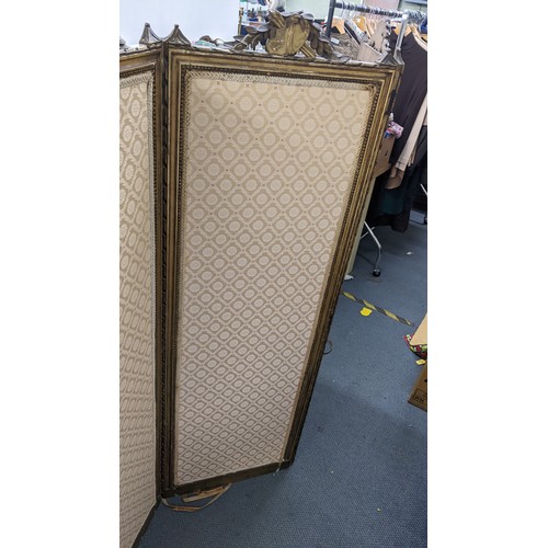 90 - A late 19th century French gilt folding three fold screen, having beige upholstery panels surrounded... 