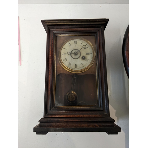 170 - An American cased mantel clock with Roman dial and pendulum marked 'R' and 'A', together with a maho... 