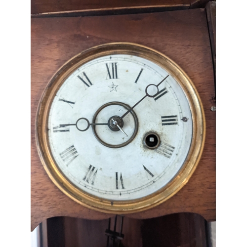 170 - An American cased mantel clock with Roman dial and pendulum marked 'R' and 'A', together with a maho... 