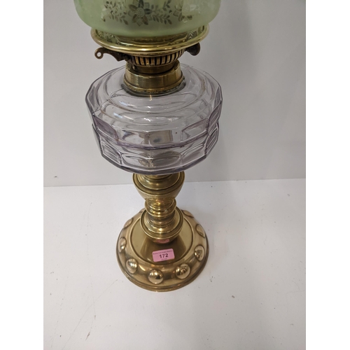 172 - A Victorian gas lamp on a rounded brass plinth with a green glass shade with floral design, 67cm hig... 