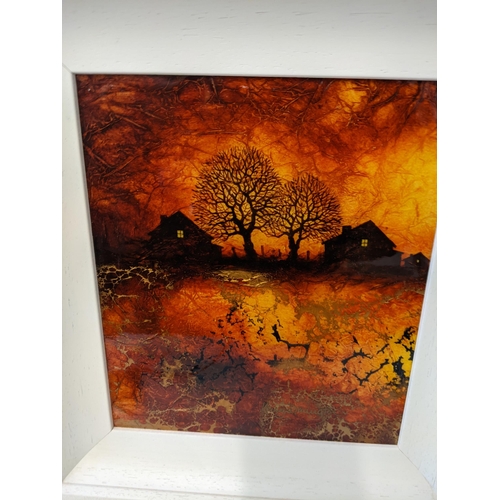 175 - A framed Kerry Darlington signed acrylic on board depicting two houses and two trees in an amber bac... 