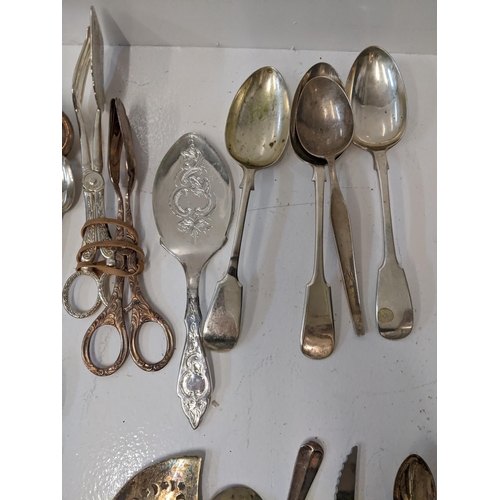 183 - A collection of silver plated flatware to include two pairs of tongs, a fish slice along with mother... 