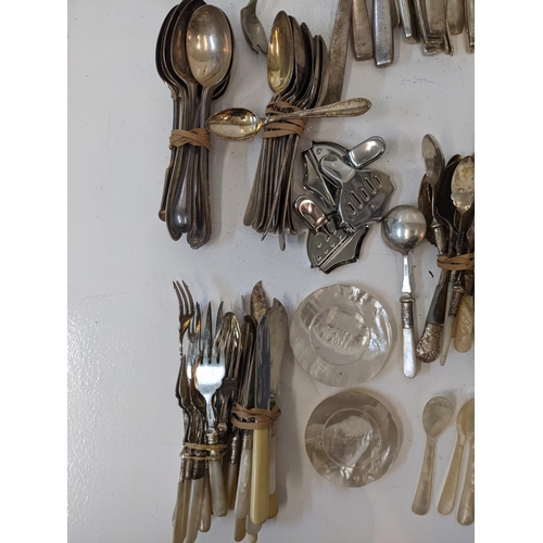 183 - A collection of silver plated flatware to include two pairs of tongs, a fish slice along with mother... 