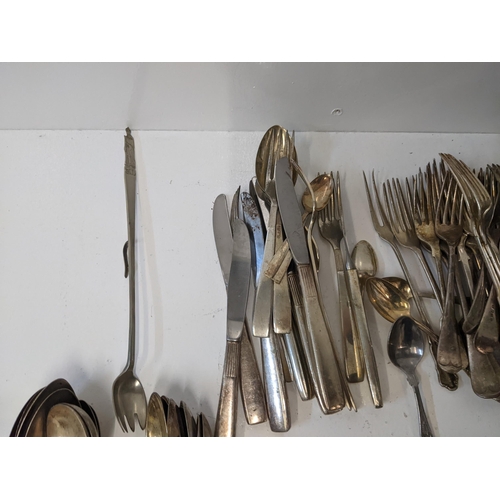 183 - A collection of silver plated flatware to include two pairs of tongs, a fish slice along with mother... 