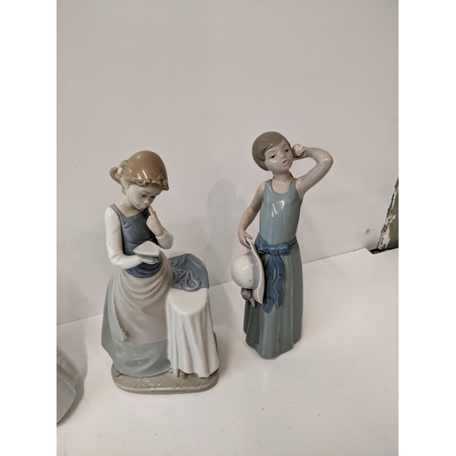 184 - LLadro and nao porcelain figures to include 'Curios girl with straw hat' 'Girl ironing' 'Girl prayin... 