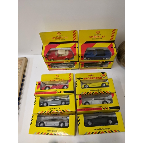 222 - A mixed lot of collectables to include ten boxed diecast model vehicles from the Shell Classic Sport... 