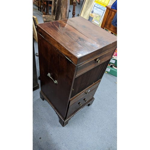 322 - A George III mahogany wash stand, the top opening to reveal a fitted interior and having a tambour d... 