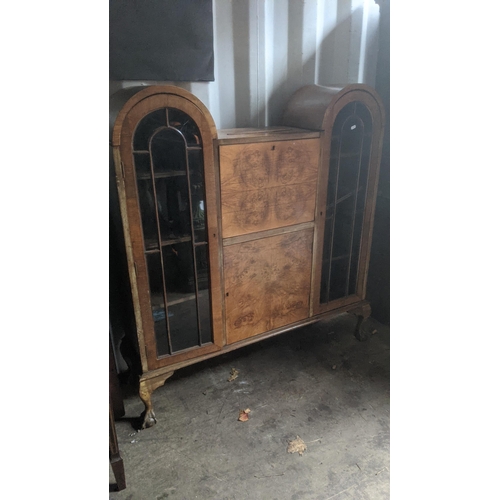 464 - An Art Deco walnut cabinet with arced top doors and fall flap, 118cm x 131.5cm x 30.5cm
Location:RC
... 