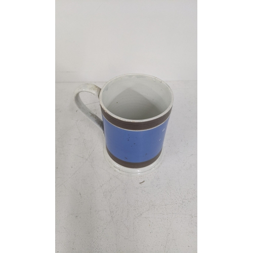 490 - A 19th century mocha ware mug with blue painted body and two ribbed borders
Location:4.1
If there is... 