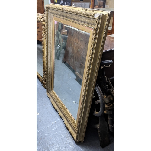 497 - A large gilt framed mirror with a beaded rim around the outer frame and a heavily decorated inside b... 