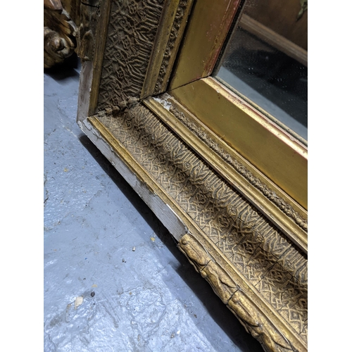 497 - A large gilt framed mirror with a beaded rim around the outer frame and a heavily decorated inside b... 