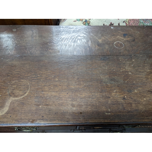 501 - An early 20th century oak chest of drawers with two short, three long drawers with brass swing handl... 