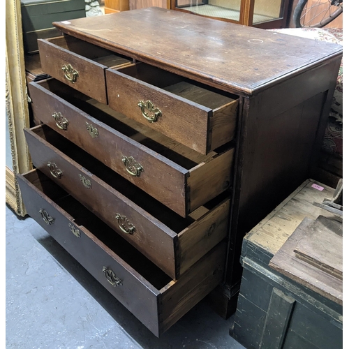 501 - An early 20th century oak chest of drawers with two short, three long drawers with brass swing handl... 