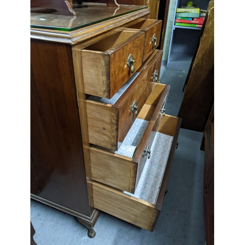 504 - An early 20th century five drawer mahogany dressing chest with a protective glass layer along with a... 