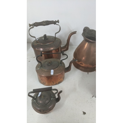 524 - A collection of Victorian copper kettles to include ships kettle and others with a half gallon coppe... 