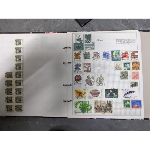 336 - A collection of worldwide stamps mounted in nine albums to include GB stamps, Chinese, Norwegian, Sp... 