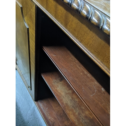 503 - An early 20th century cupboard with moulding on the top, two decorated panel doors revealing a shelv... 