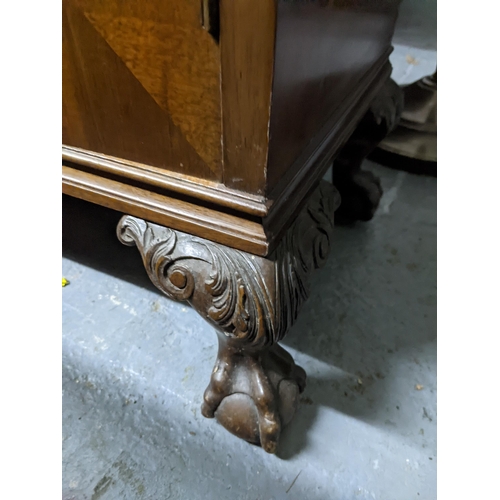 503 - An early 20th century cupboard with moulding on the top, two decorated panel doors revealing a shelv... 