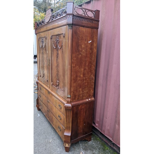 362 - An 18th century Dutch mahogany linen press, the cornice having repeated interlocking semi circle des... 