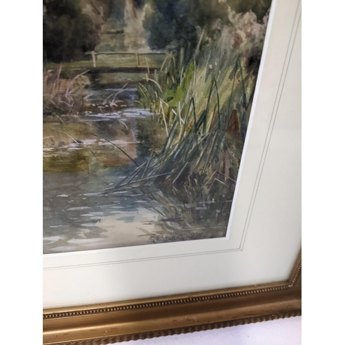 270 - A framed 19th century watercolour depicting a river scene with a church tower in the horizon, signed... 