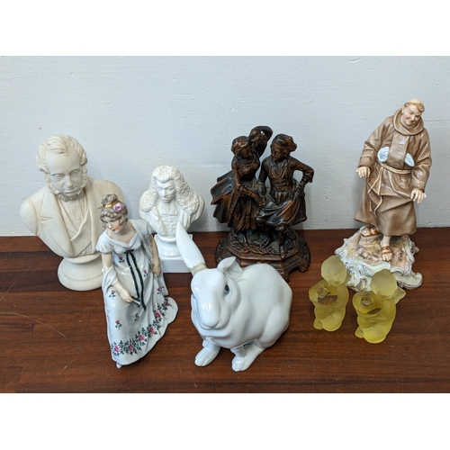 373 - A  group of ceramics figures to include: a pair of yellow glass candle sticks fashioned as cherubs, ... 