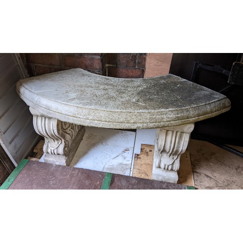 164 - A garden stoneware bench having a bow fronted seat and with two scroll framed pedestals 45cm h x 102... 