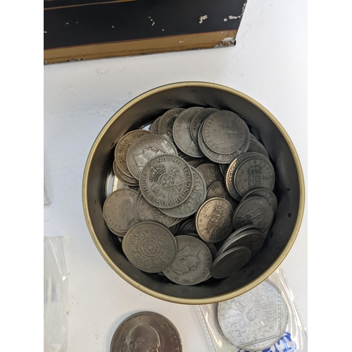 242 - A collection of coins to include various post WWII British circulated shillings, two shilling pieces... 