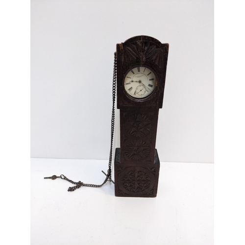 244 - A wooden carved pocket watch holder fashioned as a grandfather clock containing a silver Fattorini &... 