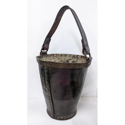 294 - A 19th century leather and studded fire bucket with a leather handle, 30cm h excluding handle
Locati... 