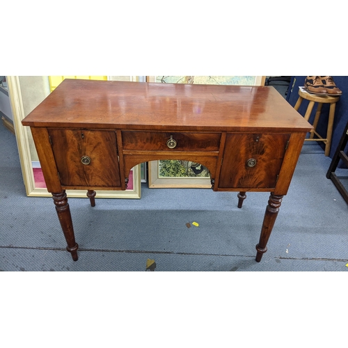 296 - An early 20th century kneehole desk having a drawer flanked by cupboards and on turned legs, 76cm h ... 