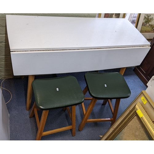 311 - A mid 20th century formica topped kitchen table and two stools
Location: LWF
If there is no conditio... 