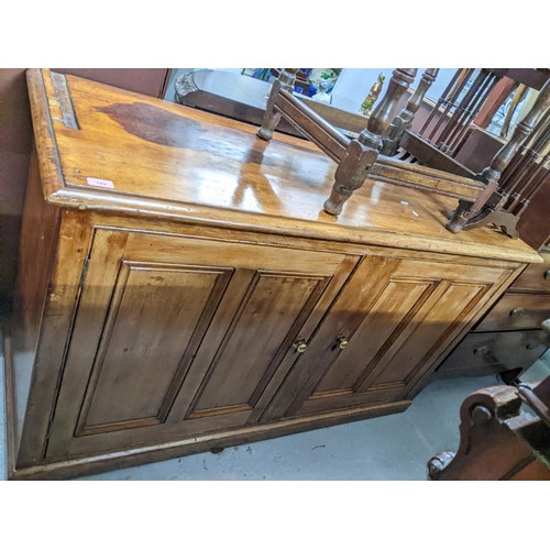 349 - An early 20th century softwood dresser base, top with moulded edge, twin panelled doors on plinth ba... 