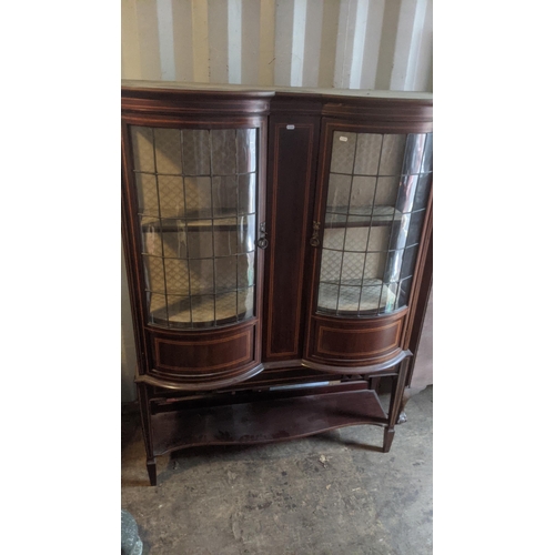 462 - An Edwardian mahogany bow fronted display cabinet having two lead glazed doors, 168.5cm h x 122cm w ... 