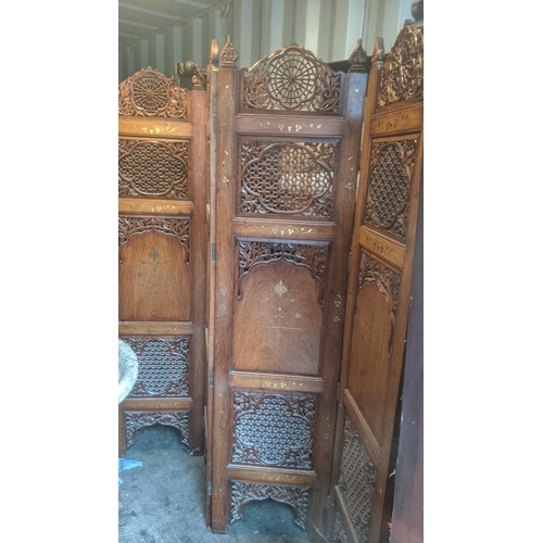 469 - An Indian teak brass inlaid hand carved four fold screen
Location: RC
If there is no condition repor... 