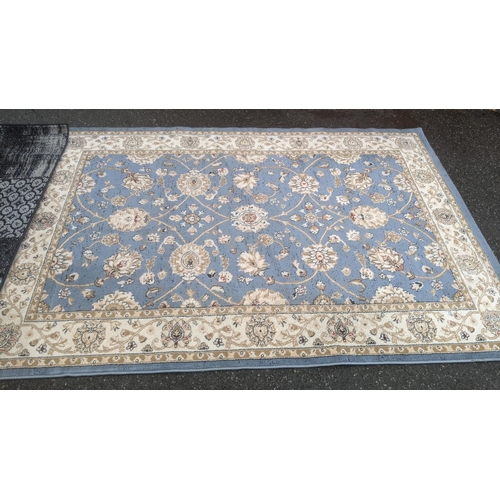 472 - Two machine woven rugs to include a blue ground repeating motifs and repeating borders example and a... 