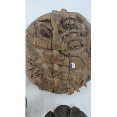 486 - Treen items to include a floral carved wall hanging plaque, a 19th century guilt moulded plaster cre... 